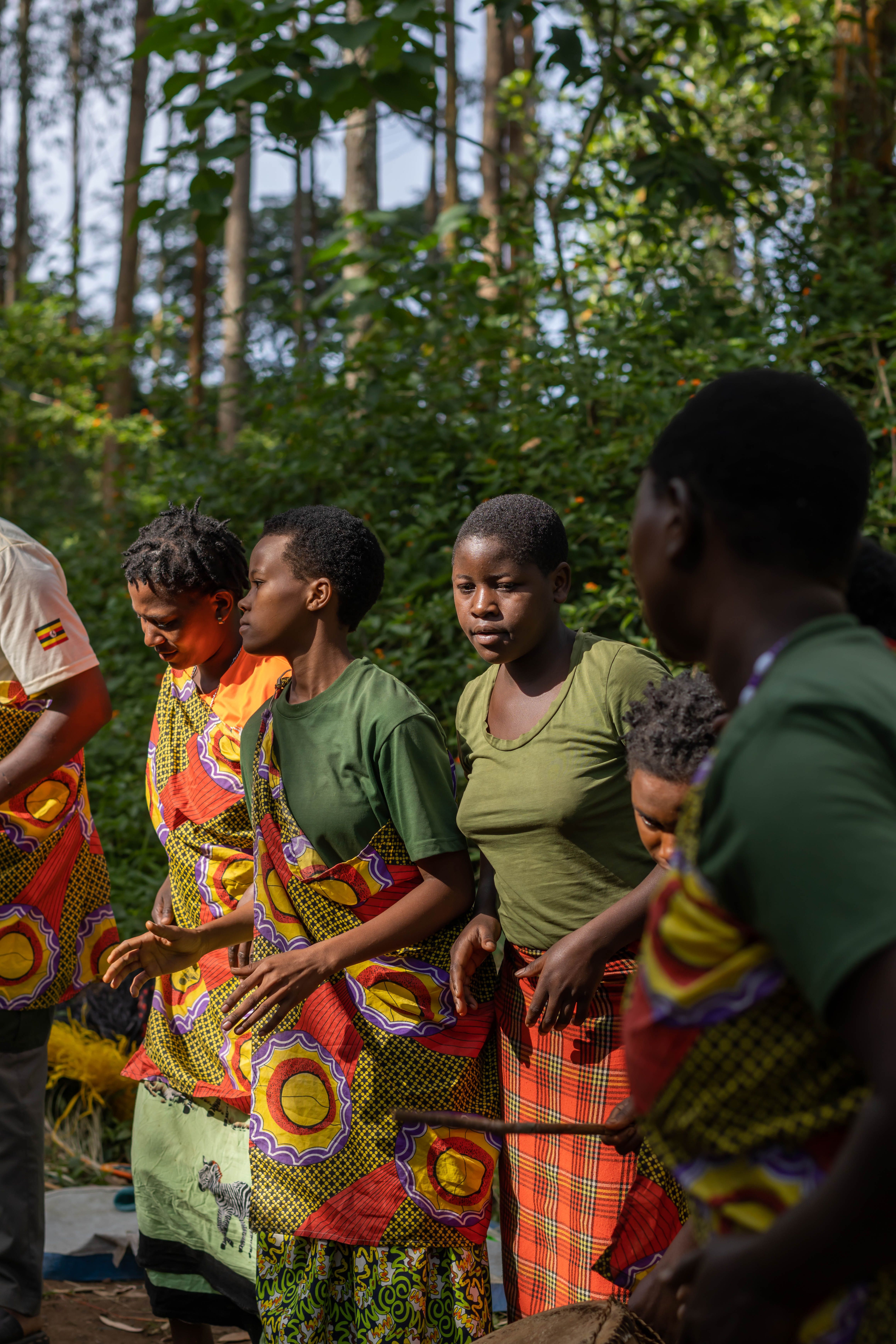 Local community guides walking with travelers through forest